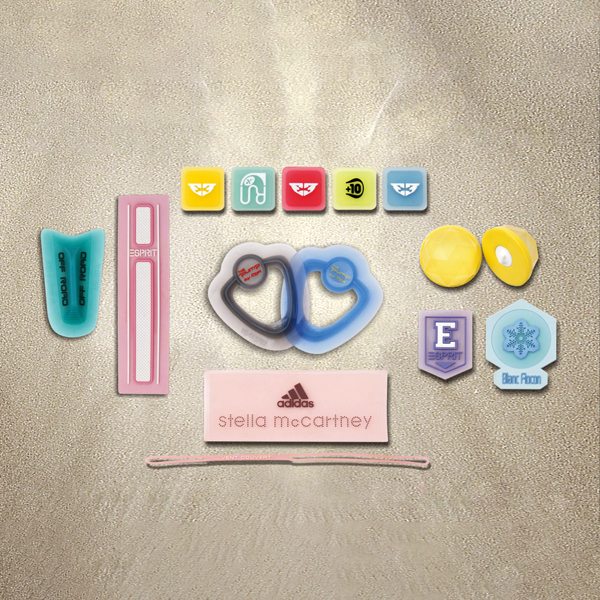 Versatile custom transparent patches: Explore a diverse selection of tags, labels, & decorative trims. Features various shapes, colors, & logos, including Adidas. Perfect for apparel & accessories.